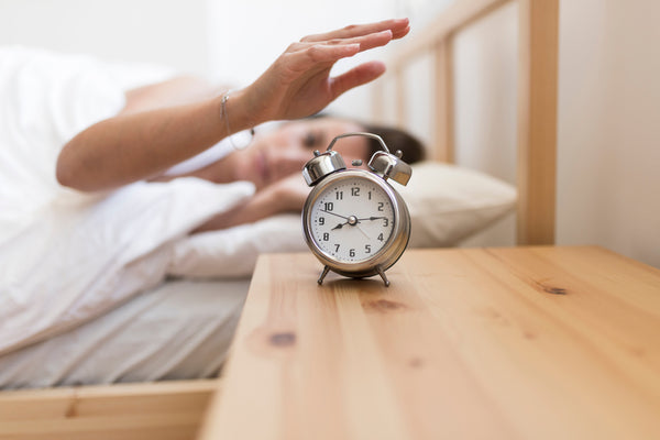 Woman turning off alarm